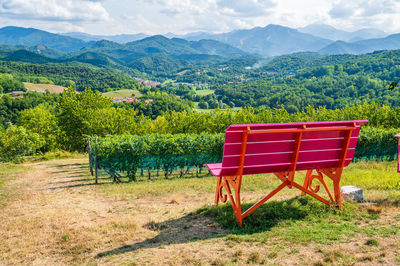 Chair on field against mountains