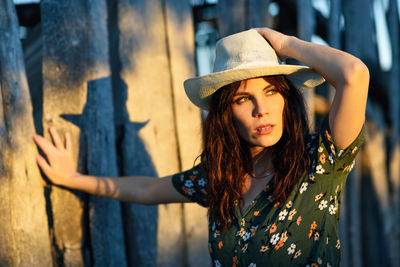 Portrait of young woman wearing hat