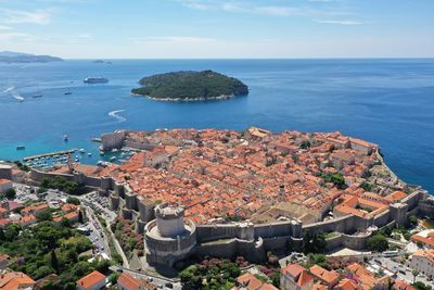 High angle view of townscape by sea against sky