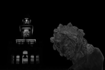 Close-up of statue against black background