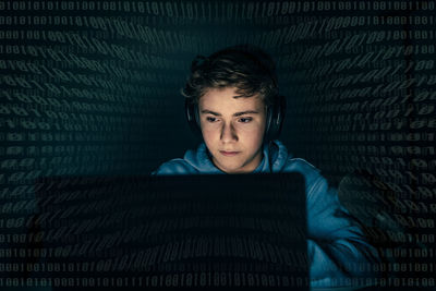 Teenager focused on computer display security protection intrusion hacker attack cyber crime concept