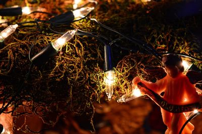 Young woman with illuminated lighting equipment at night