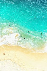 High angle view of people swimming in sea