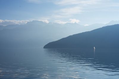 Scenic view of sea and mountains against sky