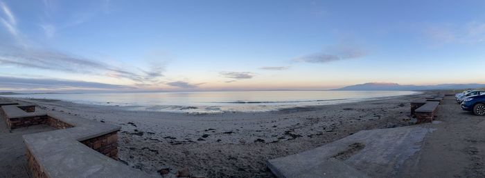 Scenic view of beach against sky during sunset