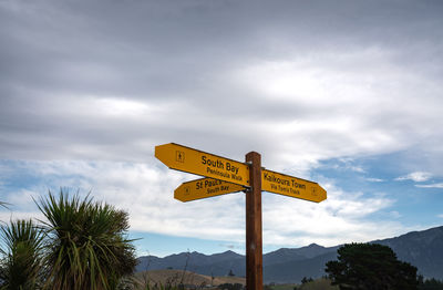 Low angle view of road sign against sky