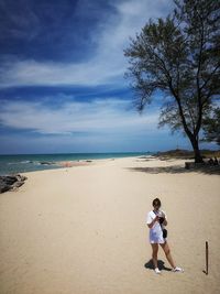 Full length of man on beach against sky