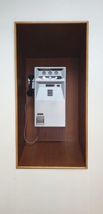 Close-up of telephone booth on wall at home