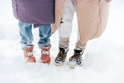 Two pairs of legs in stylish winter boots. winter fashion