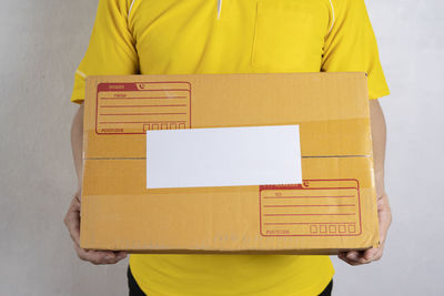 Low section of man standing on yellow box