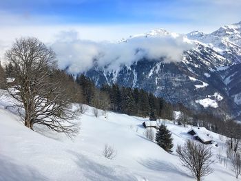 Scenic view of snow covered mountains against sky