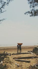 Man standing on beach against sky