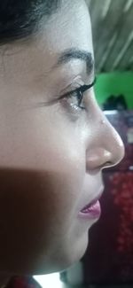 Close-up portrait of a serious young woman looking away