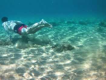 Low section of person swimming in sea