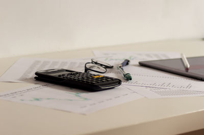 Close-up of pen and book on table