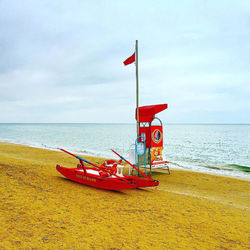 Lifeguard hut on beach against sky