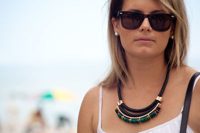 Close-up of woman wearing sunglasses at beach