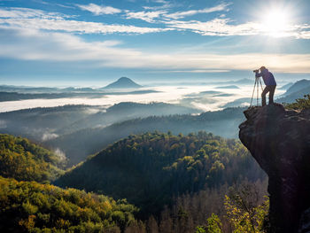 Man standing on mountain against sky