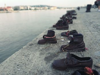 Close-up of shoes on rock in sea