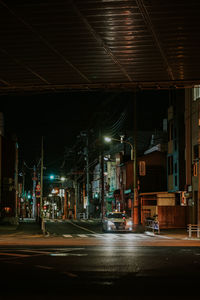 Illuminated city street at night