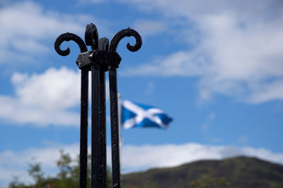 Low angle view of old pole against blue sky
