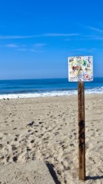 Scenic view of beach against blue sky