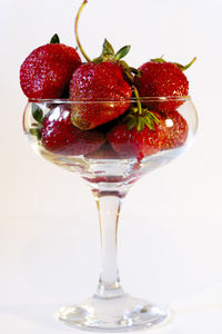 Close-up of strawberries on table against white background