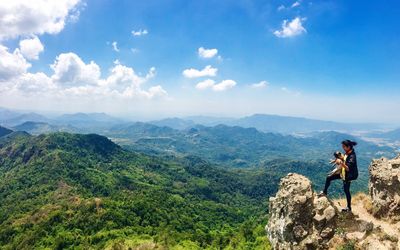 Scenic view of mountains against cloudy sky