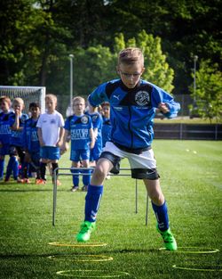 Boy playing soccer on grassy field