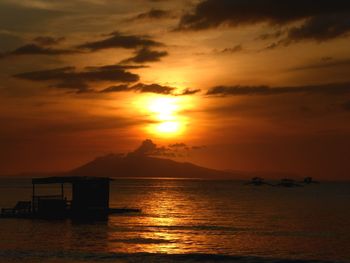 Scenic view of sea against orange sky