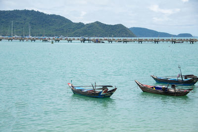 Boats in sea against sky