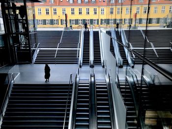 High angle view of man walking on staircase of building