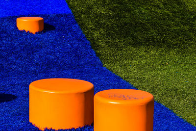 High angle view of multi colored bottles on field