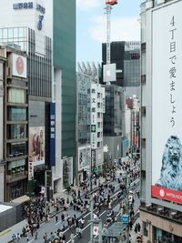 High angle view of people on street amidst buildings in city