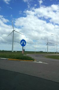 Road sign against sky