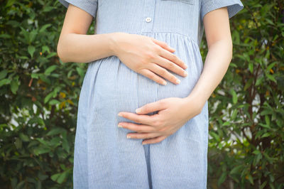 Midsection of woman holding hands