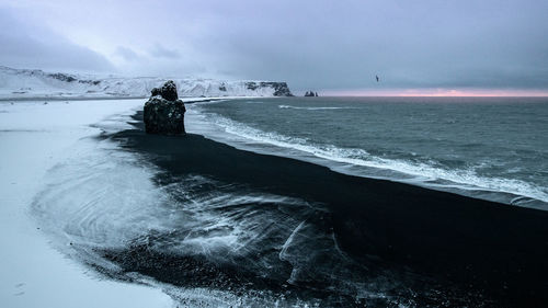 Scenic view of sea against sky during winter