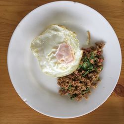 Stir fried pork with holy basil and fried egg on top of rice , thai food spicy popular concept.
