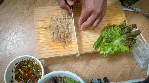 High angle view of person preparing food on cutting board
