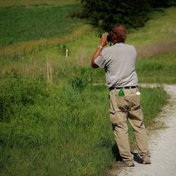 Rear view of man photographing