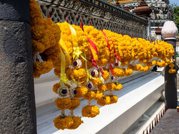 Yellow flowers, phuang malai, at the wat arun temple, temple of dawn, in bangkok, thailand.