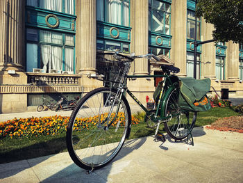 Bicycle parked on street by building