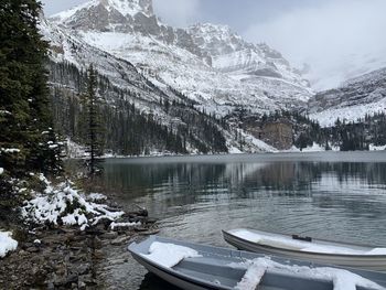 Early winter, boats on emerald green lake in mountains 