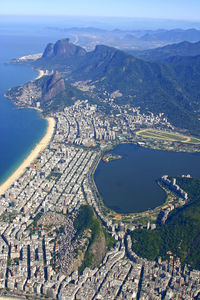 High angle view of buildings by sea against sky