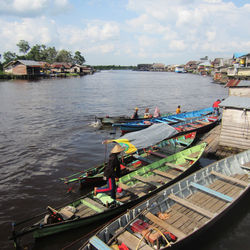 High angle view of houses by river against sky