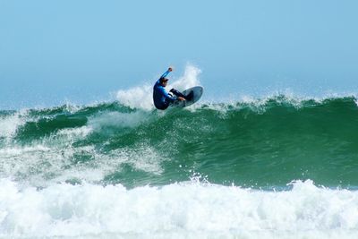 People surfing in sea