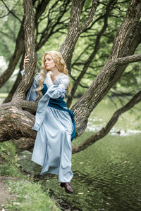 Young woman standing in forest