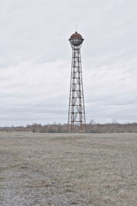 Lifeguard hut on field against sky