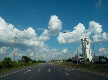 Vehicles on road against sky
