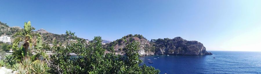 Scenic view of sea against clear blue sky